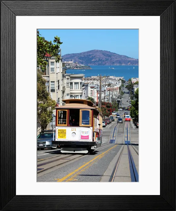 Framed Print : 13132534. Street scene with a Cable Car tram and Alcatraz Prison island in San Franciso Framed Print : 13132534. Street scene with a Cable Car tram and Alcatraz Prison island in San Franciso