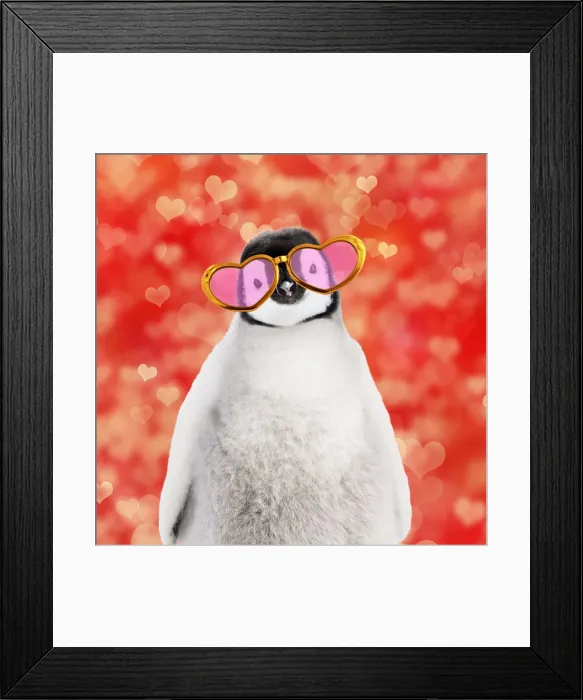 Framed Print : 13132301. Emperor penguin chick wearing heart shaped sun glasses Date Framed Print : 13132301. Emperor penguin chick wearing heart shaped sun glasses Date