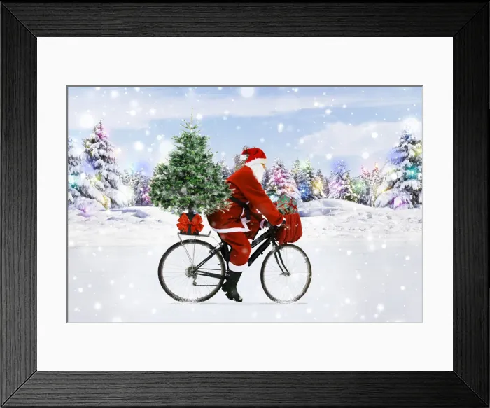 Framed Print : Santa Claus riding a bicycle through the snow with a Christmas tree Framed Print : Santa Claus riding a bicycle through the snow with a Christmas tree