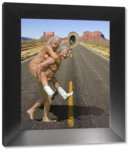 Naked couple wearing cowboy boots and hat crossing road in Monument Valley, Arizona