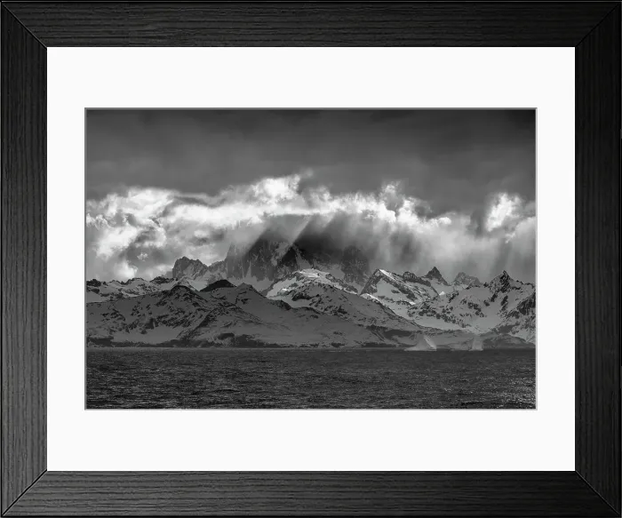 Framed Print : Black and white of South Georgia Island. Opening in clouds and Virga reveal the mountainous and glaciated landscape. Date: 18-10-2019 Framed Print : Black and white of South Georgia Island. Opening in clouds and Virga reveal the mountainous and glaciated landscape. Date: 18-10-2019