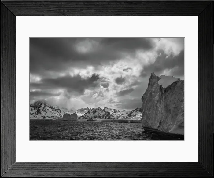 Framed Print : South Georgia Island. Black and white Landscape of iceberg floating in the Atlantic and mountain scenery. Date: 18-10-2019