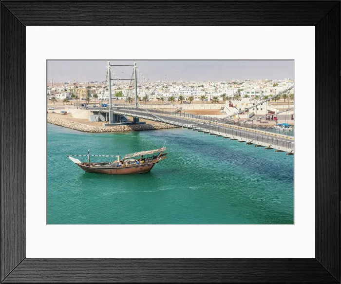 Framed Print : Middle East, Arabian Peninsula, Oman, Al Batinah South. Dhow passing under a suspension bridge. Date: 28-10-2019 Framed Print : Middle East, Arabian Peninsula, Oman, Al Batinah South. Dhow passing under a suspension bridge. Date: 28-10-2019