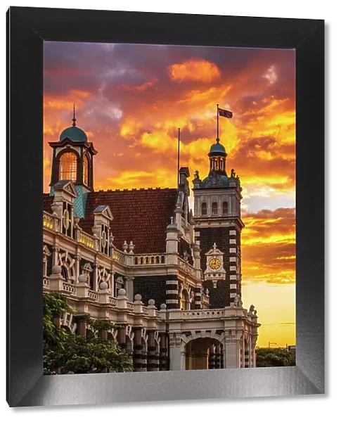 Sunset over the Dunedin Railway Station, Dunedin, South Island, New Zealand (Editorial Use Only) Date: 22-06-2021