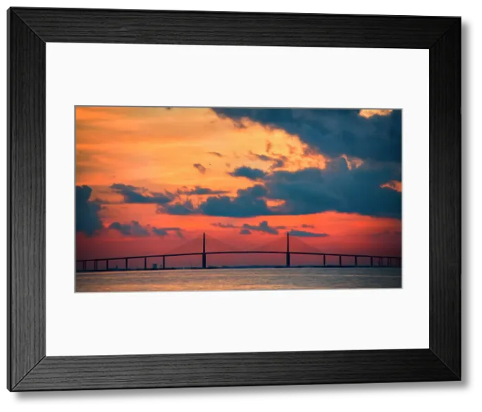 Framed Print : The Skyway Bridge over the Gulf of Mexico with the reds and oranges of the sunrise in the sky. Date: 26-07-2014 Framed Print : The Skyway Bridge over the Gulf of Mexico with the reds and oranges of the sunrise in the sky. Date: 26-07-2014