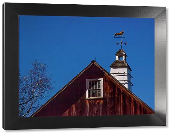 USA, New England, Vermont weather vane on top of wooden barn topped with horse Date: 08-10-2013