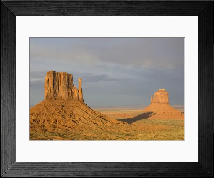 Framed Print : USA - The shadow of West Mitten Butte crawls up East Mitten Butte, the two most prominent and photogenic landmarks of the Monument Valley, the classic Wild-West landscape of sandstone buttes Framed Print : USA - The shadow of West Mitten Butte crawls up East Mitten Butte, the two most prominent and photogenic landmarks of the Monument Valley, the classic Wild-West landscape of sandstone buttes