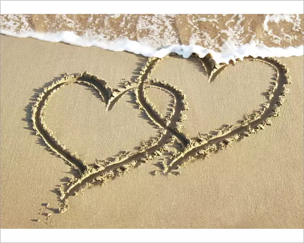 Heart drawn in the sand of a beach Digital Manipulation: added hearts together & sea
