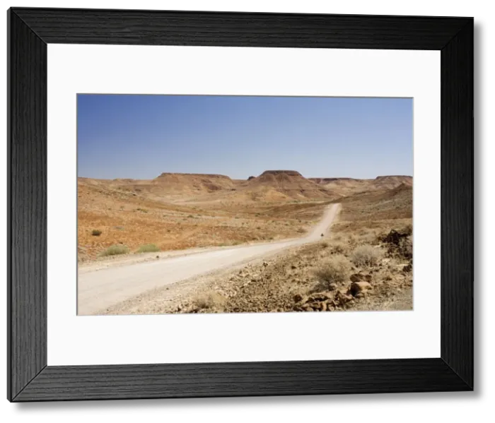 Framed Print : Gravel Roads winding through a rugged environment Near Vreede Damaraland, Namibia, Africa Framed Print : Gravel Roads winding through a rugged environment Near Vreede Damaraland, Namibia, Africa