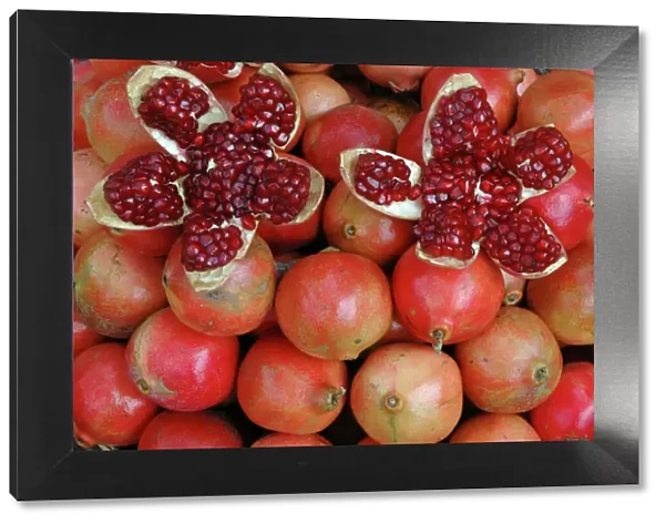 Pomegranate: opened to show seeds within sweet jelly. Widely cultivated as food, here on sale in India