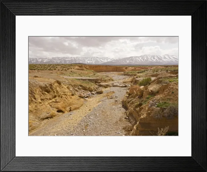 Framed Print : Dry river on the Zeida plain, with the High Atlas mountains beyond; Morocco Framed Print : Dry river on the Zeida plain, with the High Atlas mountains beyond; Morocco