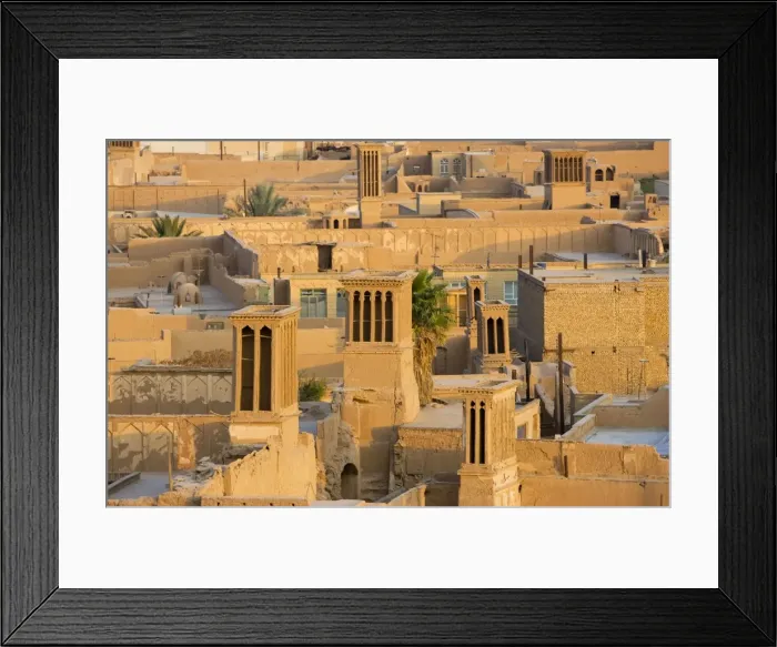 Framed Print : Wind towers, Yazd, Iran. The old town of Yazd showing wind towers, designed to catch breezes and funnel them down into the homes below as a form of cooling Framed Print : Wind towers, Yazd, Iran. The old town of Yazd showing wind towers, designed to catch breezes and funnel them down into the homes below as a form of cooling