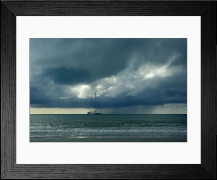 Framed Print : Thunderstorm and boat - tropical thunderstorm is brewing over the ocean at a beach near Cape Tribulation. Very dark clouds approach a sailing boat, which has anchored already, creating a very mystic atmosphere - Cape Tribulation National Park Framed Print : Thunderstorm and boat - tropical thunderstorm is brewing over the ocean at a beach near Cape Tribulation. Very dark clouds approach a sailing boat, which has anchored already, creating a very mystic atmosphere - Cape Tribulation National Park