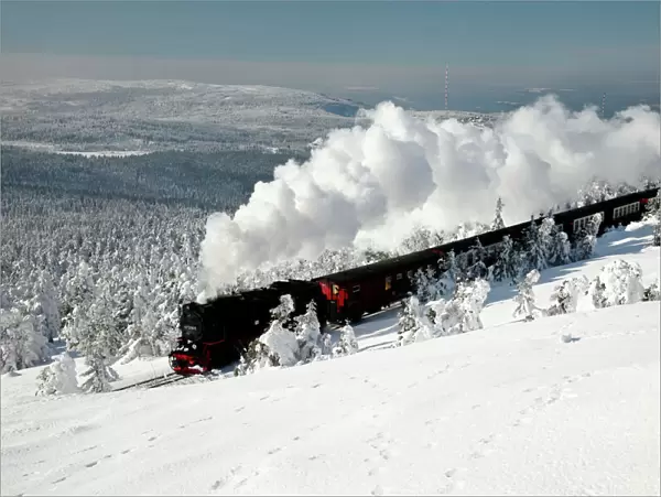 Small Gauge Steam Locomotive - riding through snow covered winter landscape - Brocken - National Park arz Mountains - Sachsen-Anhalt - Germany