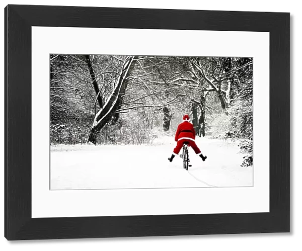 Father Christmas - in snow - on bicycle freewheeling