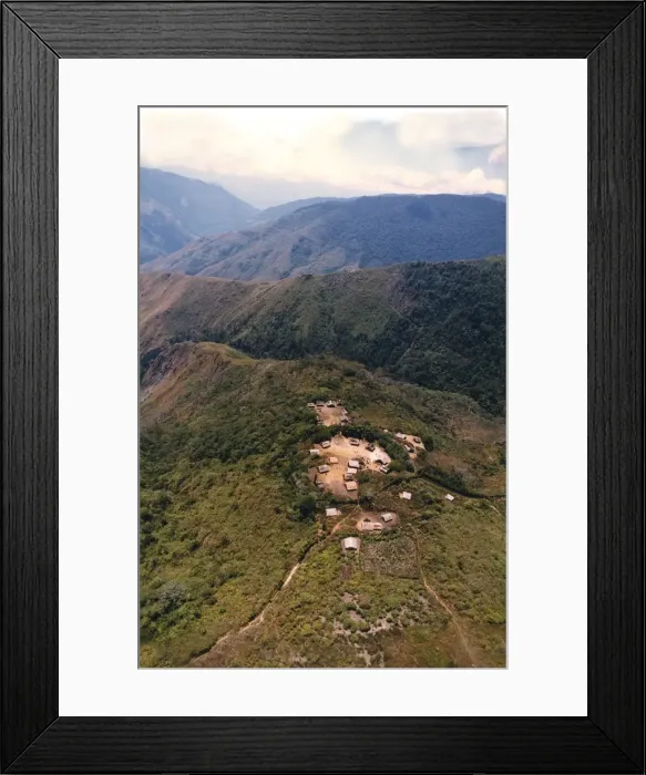 Framed Print : An aerial view of villagers congregating in the village square of a remote mountain village in Morobe Province, Papua New Guinea. The steep walk-track on the second ridge connects to the village on the top of that ridge Framed Print : An aerial view of villagers congregating in the village square of a remote mountain village in Morobe Province, Papua New Guinea. The steep walk-track on the second ridge connects to the village on the top of that ridge