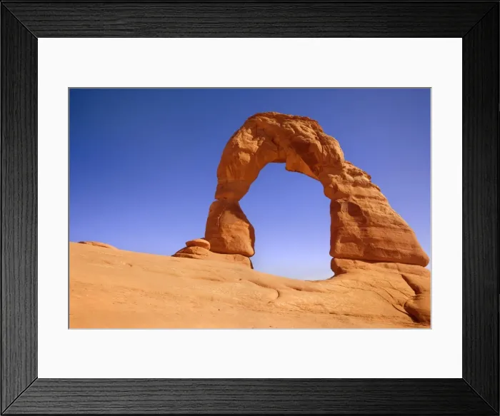 Framed Print : Delicate Arch - delicately sculptured sandstone arch standing on a slickrock slope. In late evening - Arches National Park, Utah, USA Framed Print : Delicate Arch - delicately sculptured sandstone arch standing on a slickrock slope. In late evening - Arches National Park, Utah, USA