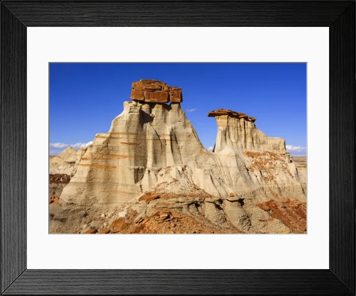 Framed Print : Hoodoos - eroded clay sculptures with rocks balanced on their tops located amidst badlands - Bisti Badlands Wilderness Area - New Mexico - USA Framed Print : Hoodoos - eroded clay sculptures with rocks balanced on their tops located amidst badlands - Bisti Badlands Wilderness Area - New Mexico - USA