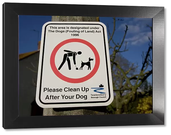 Please clean up after your dog sign, UK - it is now obligatory to clean up dog mess and this sign on a lamp post reminds dog walkers in Woodmancote, Gloucestershire