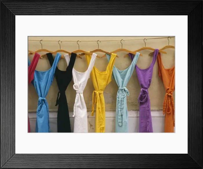 Framed Print : France Provence. Multi coloured dresses hanging in a row Framed Print : France Provence. Multi coloured dresses hanging in a row
