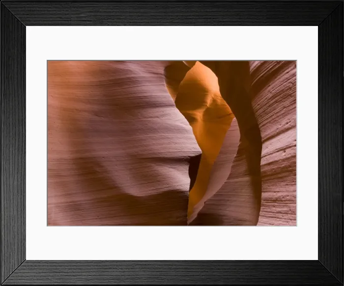 Framed Print : USA - Light that penetrates into the narrow canyon walls creates beautiful hues on the graceful curves of sandstone rock in the Lower Antelope Canyon, probably the most famous slot canyon in the Southwest. Antelope Canyon