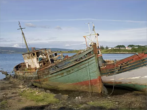 Old fishing boats rotting on beach, Isle of Mull, Scotland, UK