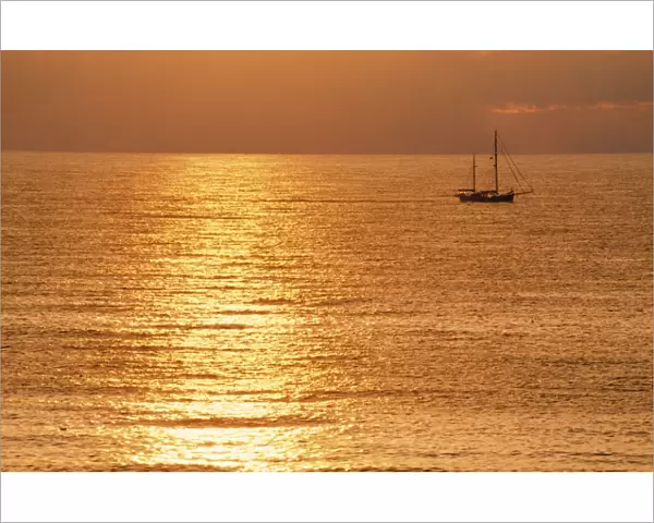 Sunset - over sea with small boat