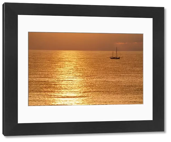 Sunset - over sea with small boat
