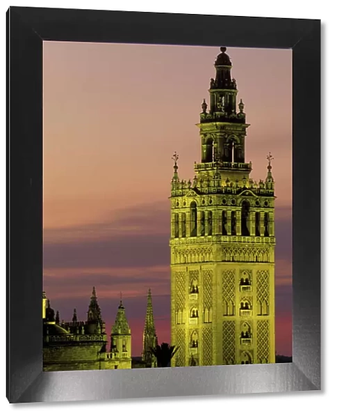 Spain - Sevilla's most beautiful building, the Moorish Giralda, was built from 1184-96, but later on suffered many additions; illuminated at dusk. Province of Sevilla, Andalucia, Spain