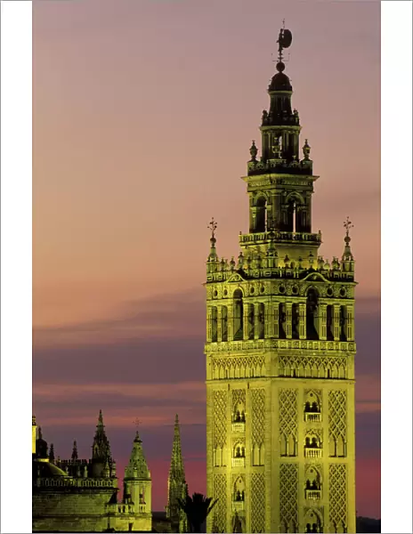 Spain - Sevilla's most beautiful building, the Moorish Giralda, was built from 1184-96, but later on suffered many additions; illuminated at dusk. Province of Sevilla, Andalucia, Spain