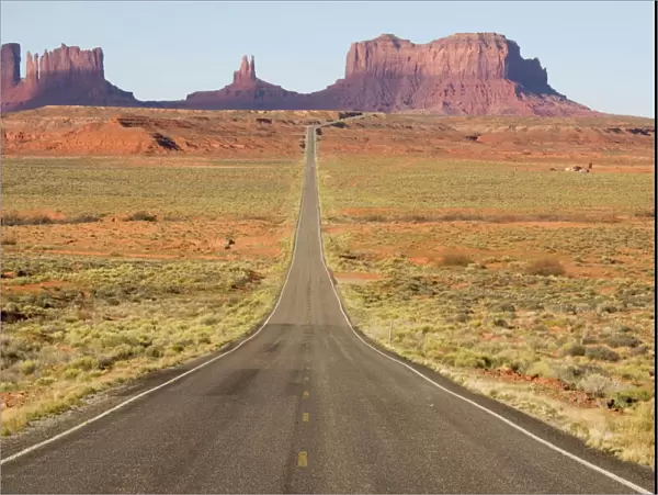 USA - One of the most famous images of the Monument Valley is the long straight road (US 163) leading across flat desert towards sandstone buttes and pinnacles of rock. Monument Valley Tribal Park, Navajo Nation, Arizona / Utah, USA