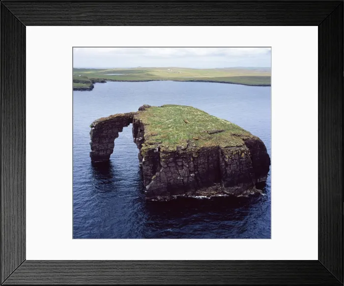 Framed Print : Aerial image of Scotland, UK: Dore Holm, a small islet with a natural arch, off the south coast of Esha Ness, in the west of Mainland, Shetland Framed Print : Aerial image of Scotland, UK: Dore Holm, a small islet with a natural arch, off the south coast of Esha Ness, in the west of Mainland, Shetland