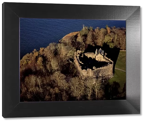 Aerial image of Scotland, UK: Dunstaffnage Castle, a partially ruined 13th century castle, situated on a platform of conglomerate rock on a promontory at the south-west of the entrance to Loch Etive, surrounded on three sides by the sea, near Oban