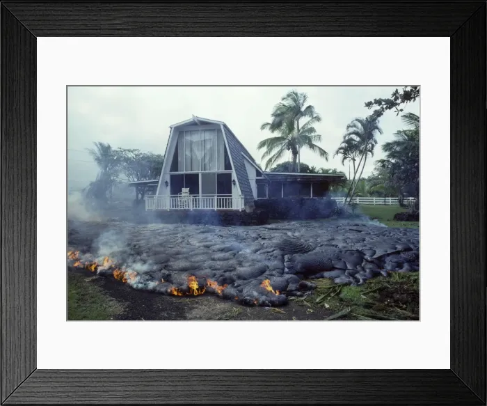 Framed Print : USA - Hawaii - Big Island - Eruption of the Pu'u O'o Vent - a vent of the Kilauea Volcano - Advancing lava flow surrounds a house in the village of Kalapana Gardens on the south shore of the island Framed Print : USA - Hawaii - Big Island - Eruption of the Pu'u O'o Vent - a vent of the Kilauea Volcano - Advancing lava flow surrounds a house in the village of Kalapana Gardens on the south shore of the island