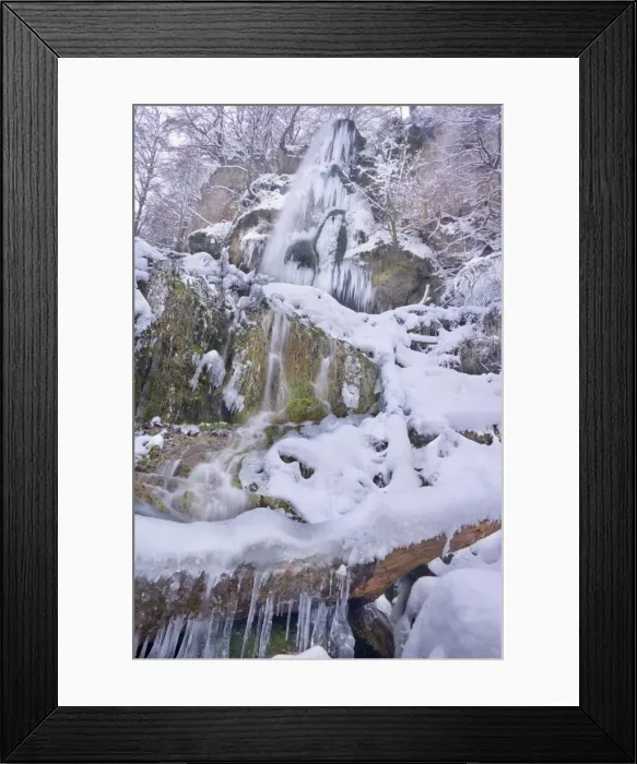 Framed Print : Frozen Waterfall - a waterfall in winter with numerous icicles and snow and ice covered rocks, branches and trees - Swabian Alb - Baden-Wuerttemberg - Germany