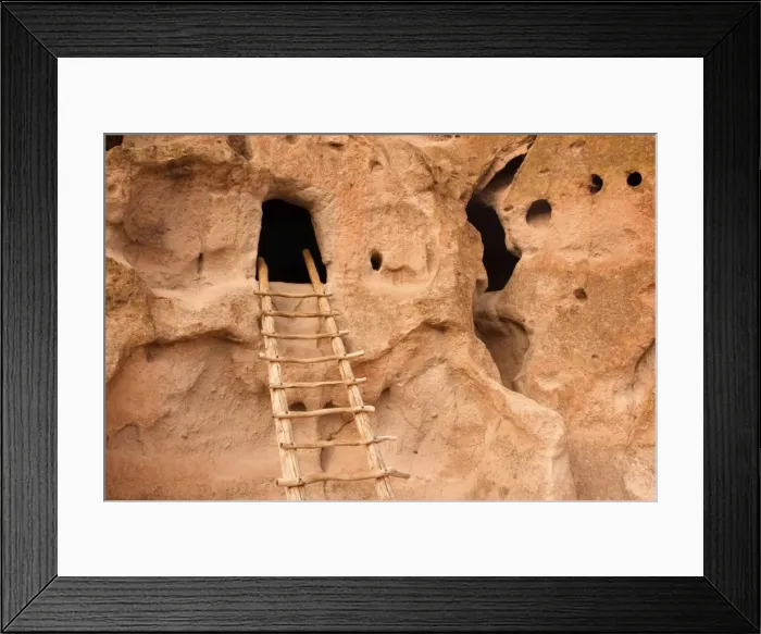 Framed Print : Pueblo Ruins - cave dwelling in Frijoles Canyon - wooden ladders lead into the cave by hand carved openings - these ruins were occupied for nearly 500 years until the late 1500s - Bandelier National Monument - Jemenez Mountains - New Mexico - USA Framed Print : Pueblo Ruins - cave dwelling in Frijoles Canyon - wooden ladders lead into the cave by hand carved openings - these ruins were occupied for nearly 500 years until the late 1500s - Bandelier National Monument - Jemenez Mountains - New Mexico - USA