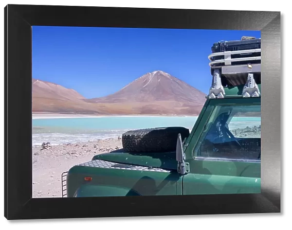 Landrover at Laguna Verde - a Landrover Defender is parked at turqoise coloured Green Laguna and volcano Lincancabur on the stark Altiplano located at an altitude of about 4300 m above sea level - southwestern Bolivia - Province Potosi - Bolivia