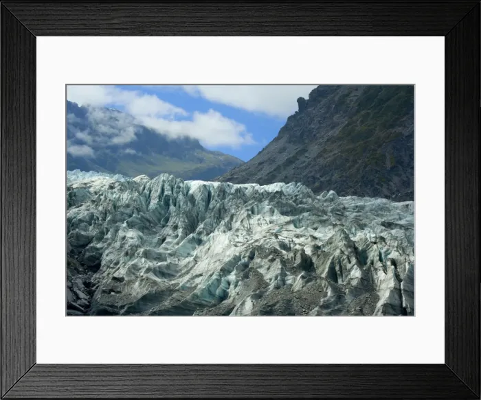 Framed Print : Fox Glacier river of ice cutting through glacial valley nestled amidst mountains covered by primeval rainforest Westland National Park, West Coast, South Island, New Zealand