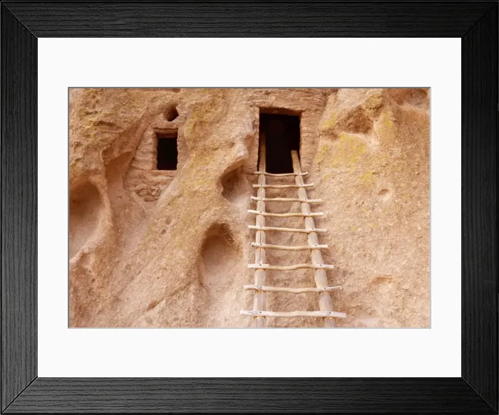 Framed Print : Pueblo Ruins - cave dwelling in Frijoles Canyon - wooden ladders lead into the cave by hand carved openings - these ruins were occupied for nearly 500 years until the late 1500s - Bandelier National Monument - Jemenez Mountains - New Mexico - USA