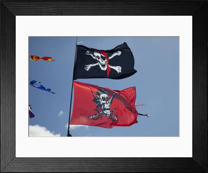 Framed Print : Skull and crossbones flags flying against blue sky - Greenbelt Festival 2010 - Cheltenham - UK
