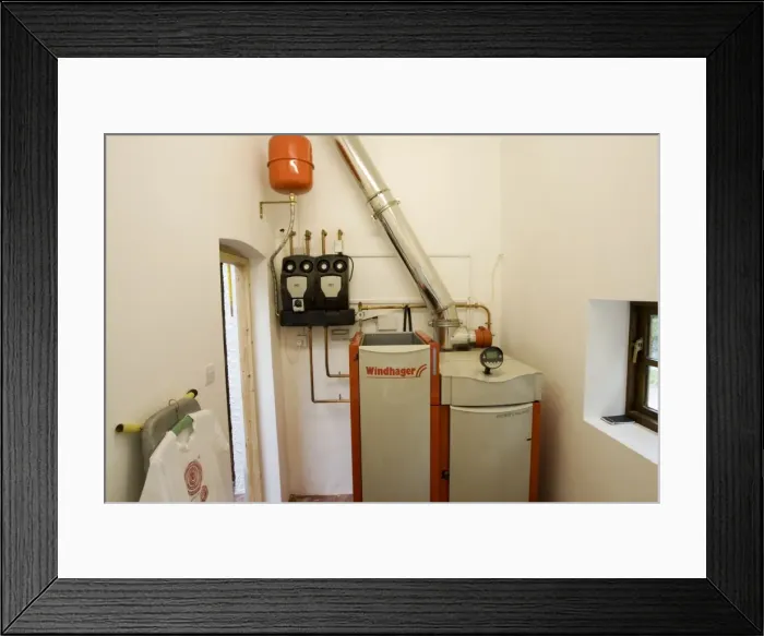 Framed Print : Boiler - Windhager Austrian wood pellet fired domestic biomass boiler produces heat for thermal store using small wood pellets supplied from a large external hopper installed in small cottage Cotswolds UK Framed Print : Boiler - Windhager Austrian wood pellet fired domestic biomass boiler produces heat for thermal store using small wood pellets supplied from a large external hopper installed in small cottage Cotswolds UK