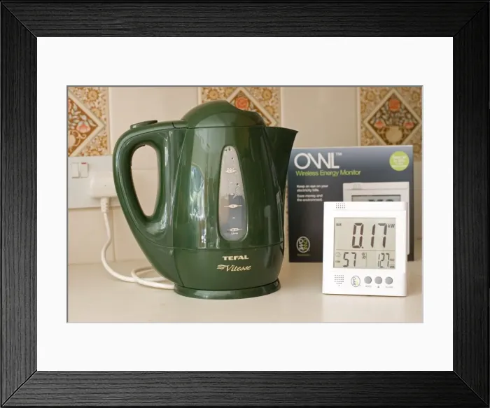 Framed Print : Owl energy monitor set to measure kW with green kettle turned off on kitchen worktop UK. Owl monitors formerly sold as Electrisave measure current eletricity use in either kW or carbon emissions as well as cost per hour Framed Print : Owl energy monitor set to measure kW with green kettle turned off on kitchen worktop UK. Owl monitors formerly sold as Electrisave measure current eletricity use in either kW or carbon emissions as well as cost per hour