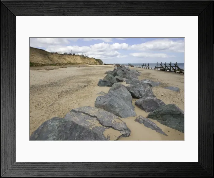 Framed Print : Rocks dumped on beach to reduce severe coastal erosion Happisburgh North Norfolk Coast UK