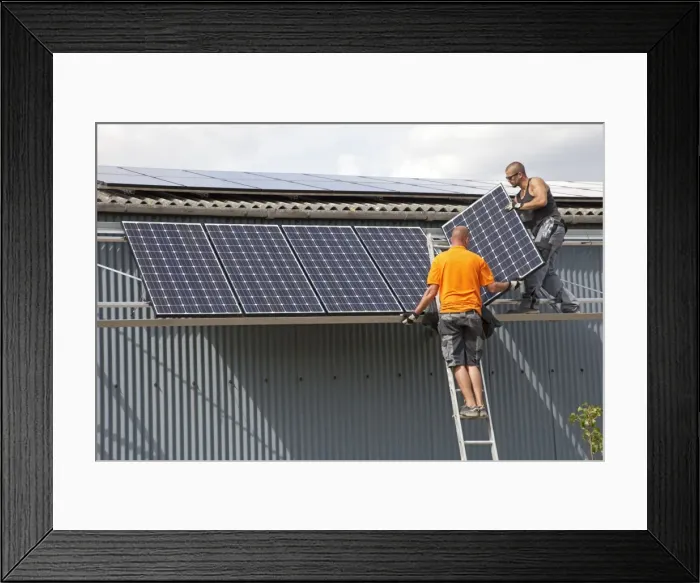 Framed Print : Two engineers installing photovoltaic solar PV panels on roof of steel barn Cotswolds UK Framed Print : Two engineers installing photovoltaic solar PV panels on roof of steel barn Cotswolds UK
