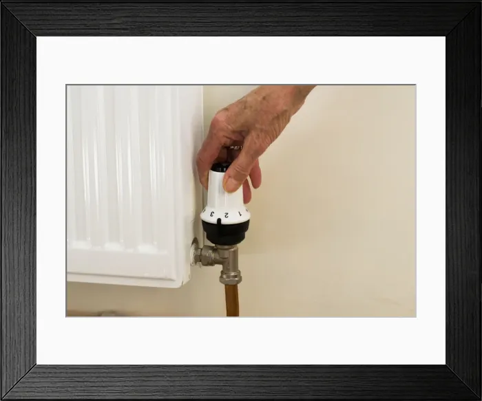Framed Print : Radiator - reducing temperature setting on radiator thermostat UK Framed Print : Radiator - reducing temperature setting on radiator thermostat UK