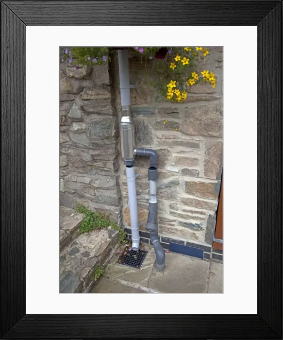 Framed Print : Wisey stainless steel rain water diverter and filter installed in downpipe of eco house UK Framed Print : Wisey stainless steel rain water diverter and filter installed in downpipe of eco house UK