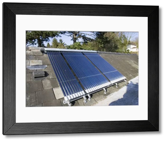 Framed Print : Roof mounted Vaillant aurotherm evacuated tube solar collectors installed on slate roof Cotswolds UK Framed Print : Roof mounted Vaillant aurotherm evacuated tube solar collectors installed on slate roof Cotswolds UK