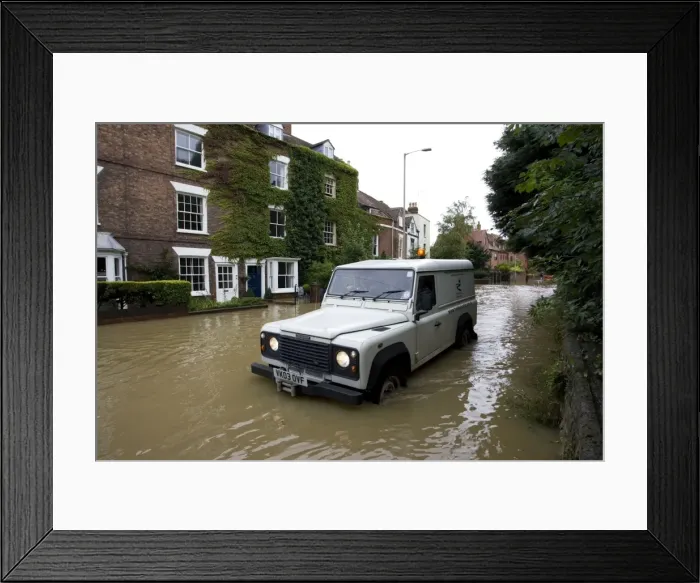 Framed Print : Flooding - Landrover driving along flooded road near Tewkesbury Abbey Gloucestershire UK Level of Rivers Avon and Severn almost at 1947 levels on July 21 2007