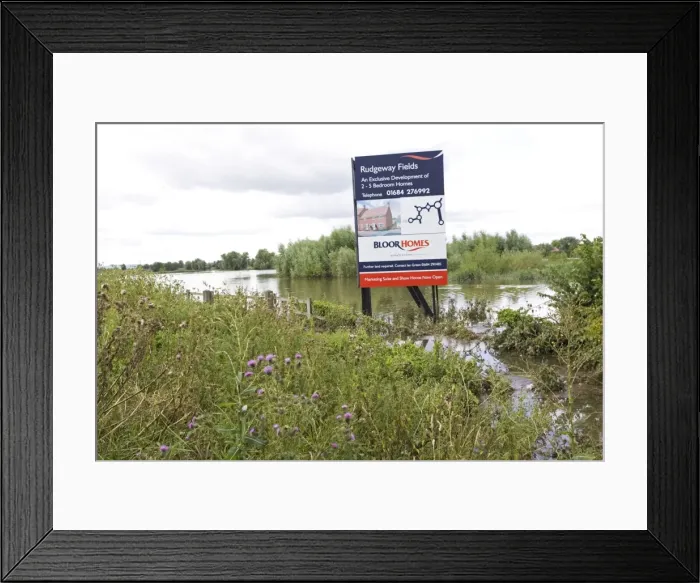 Framed Print : Flooding - Large bill board adverting exclusive development of new houses on inundated flood plain Newtown Tewkesbury Gloucestershire UK following unprecedented flooding of Rivers Severn and Avon July 2007 Framed Print : Flooding - Large bill board adverting exclusive development of new houses on inundated flood plain Newtown Tewkesbury Gloucestershire UK following unprecedented flooding of Rivers Severn and Avon July 2007