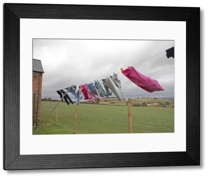 Framed Print : Washing line of clothes blowing in high wind - Mickleton - Gloucestershire - UK Framed Print : Washing line of clothes blowing in high wind - Mickleton - Gloucestershire - UK